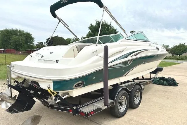 Slide: The Image of 2004 Sea Ray 270 Sundeck boat on trailer, featuring sleek design and green accents. - 6