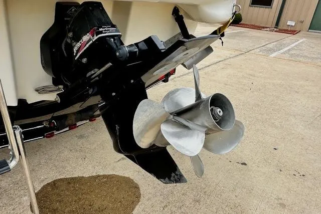 Slide: The Image of 2004 Sea Ray 270 Sundeck boat propeller and outdrive on concrete surface. - 8
