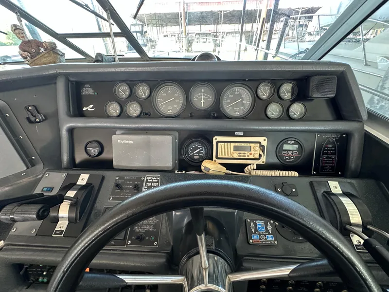 Slide: The Image of Dashboard of a 1993 Sea Ray Sundancer 370 boat with steering wheel and instruments. - 17