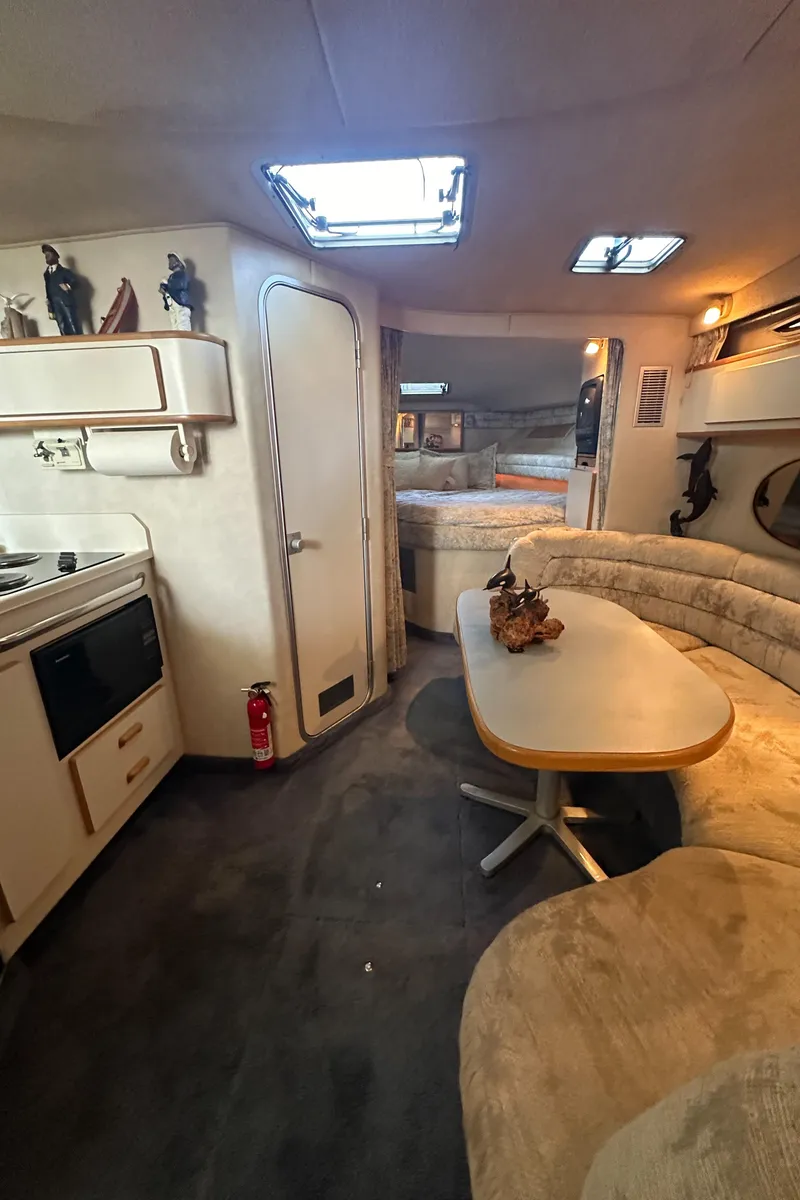 Slide: The Image of Interior of a 1993 Sea Ray Sundancer 370 yacht with kitchen and seating area. - 23