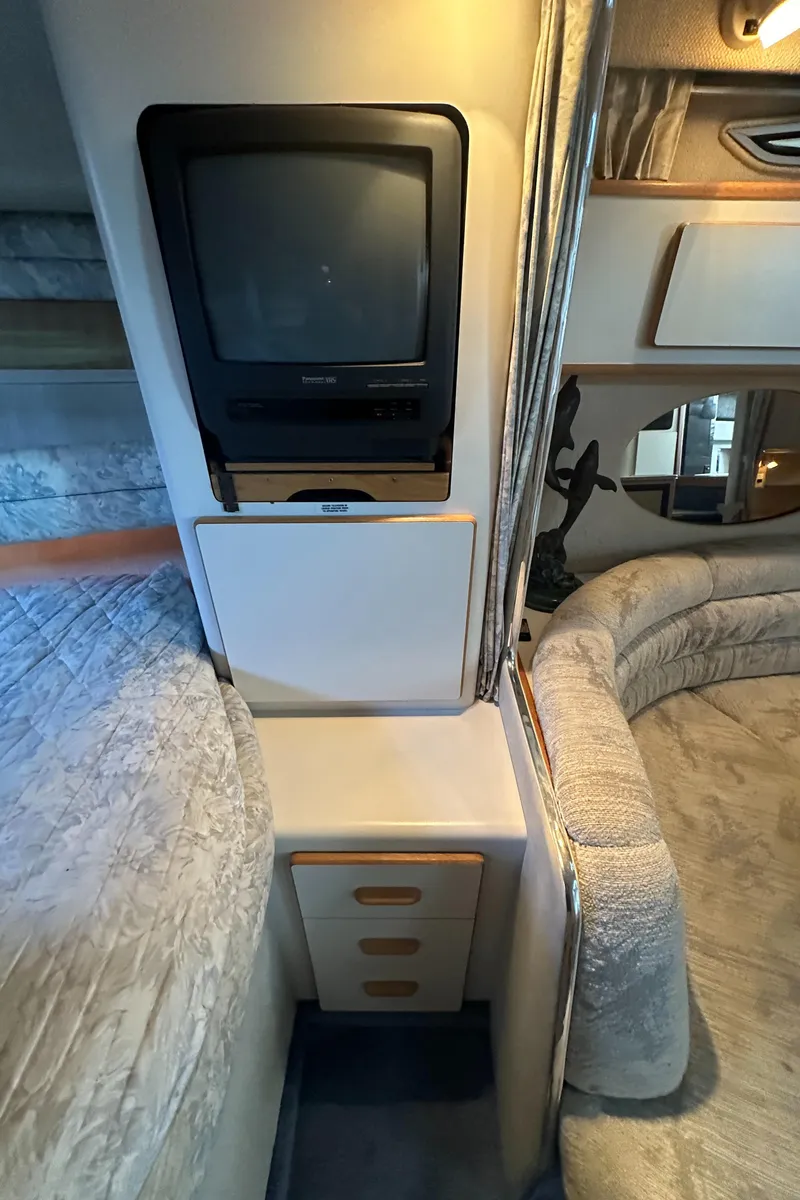 Slide: The Image of 1993 Sea Ray Sundancer 370 interior with TV and storage drawers. - 29