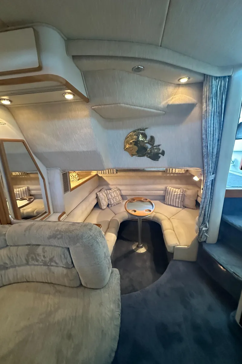 Slide: The Image of Interior of a 1993 Sea Ray Sundancer 370 yacht with cozy seating area. - 30