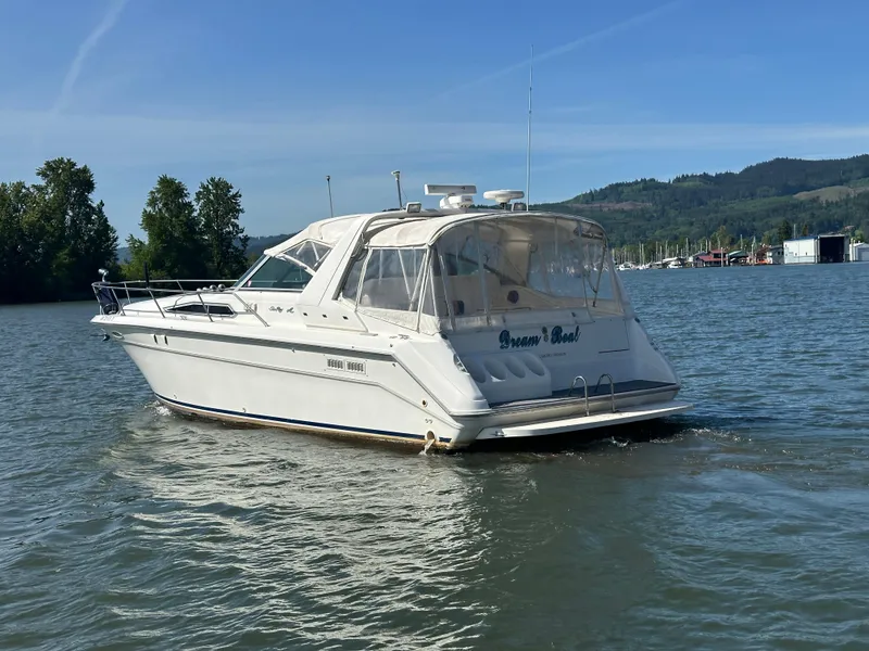 Slide: The Image of 1993 Sea Ray Sundancer 370 on calm water near wooded shoreline. - 4