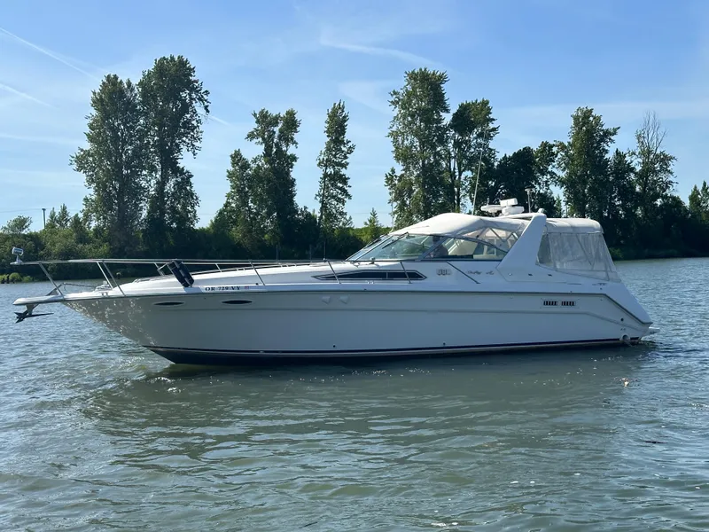 Slide: The Image of 1993 Sea Ray Sundancer 370 on calm water with trees in background. - 42