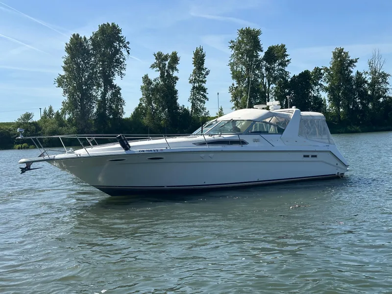 Slide: The Image of 1993 Sea Ray Sundancer 370 on calm water with trees in background. - 43