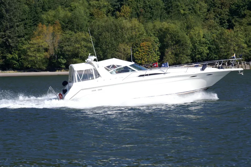 Slide: The Image of 1993 Sea Ray Sundancer 370 cruising on a serene lake. - 49