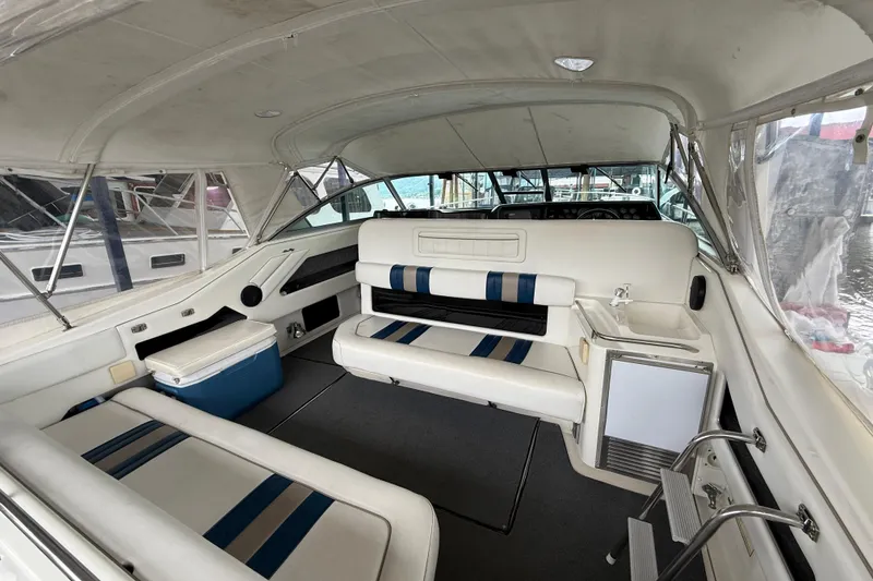 Slide: The Image of Interior of a 1993 Sea Ray Sundancer 370 boat with white seating and blue accents. - 51