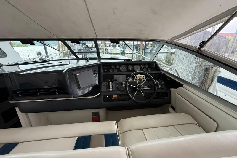 Slide: The Image of Cockpit of 1993 Sea Ray Sundancer 370 with steering wheel and control panel. - 52