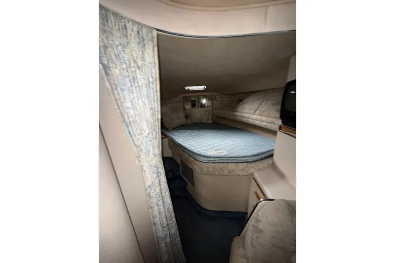 Slide: The Image of Interior cabin of 1993 Sea Ray Sundancer 370 with cozy bed and curtains. - 56