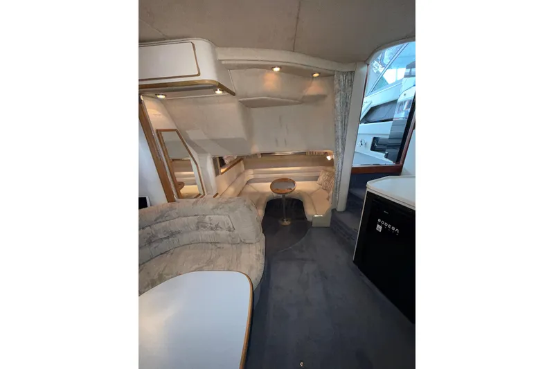 Slide: The Image of Interior of 1993 Sea Ray Sundancer 370 yacht, featuring cozy seating and modern amenities. - 59