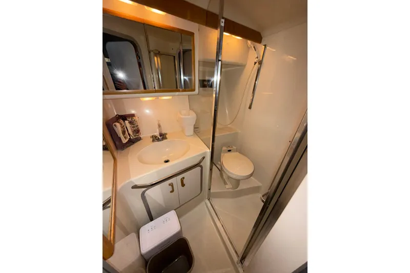 Slide: The Image of Bathroom interior of 1993 Sea Ray Sundancer 370 yacht, featuring sink, toilet, and shower. - 61