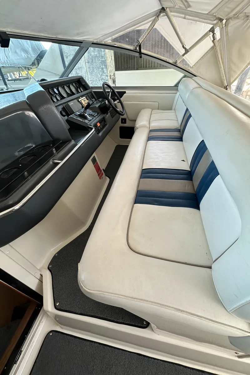 Slide: The Image of Interior of a 1993 Sea Ray Sundancer 370 with blue and white seating. - 9