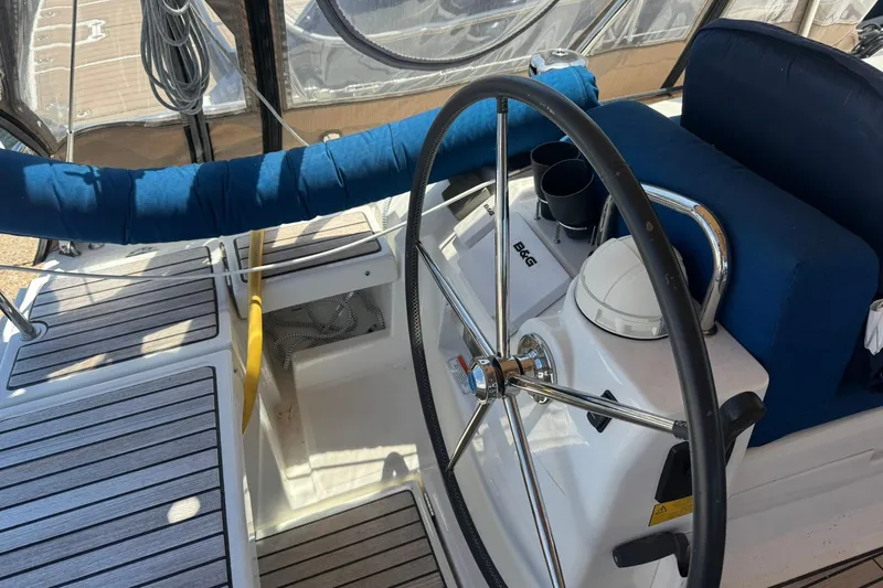 Slide: The Image of Steering wheel of a 2014 Beneteau Oceanis 45 sailboat, featuring B&G navigation equipment. - 12