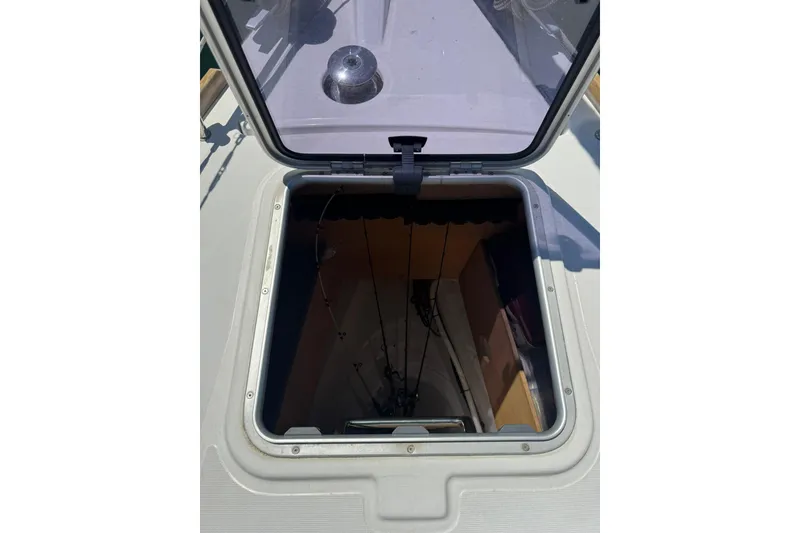 Slide: The Image of Open hatch on 2014 Beneteau Oceanis 45 sailboat, revealing interior space. - 15