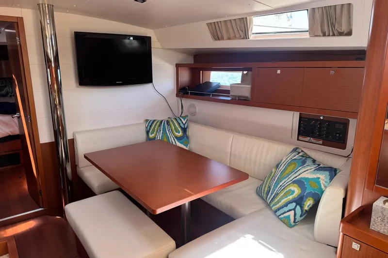 Slide: The Image of Interior of 2014 Beneteau Oceanis 45 yacht with cozy seating and modern decor. - 17