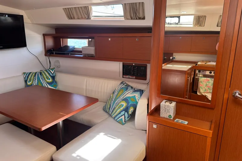Slide: The Image of Interior of 2014 Beneteau Oceanis 45 yacht with cozy seating and modern amenities. - 18