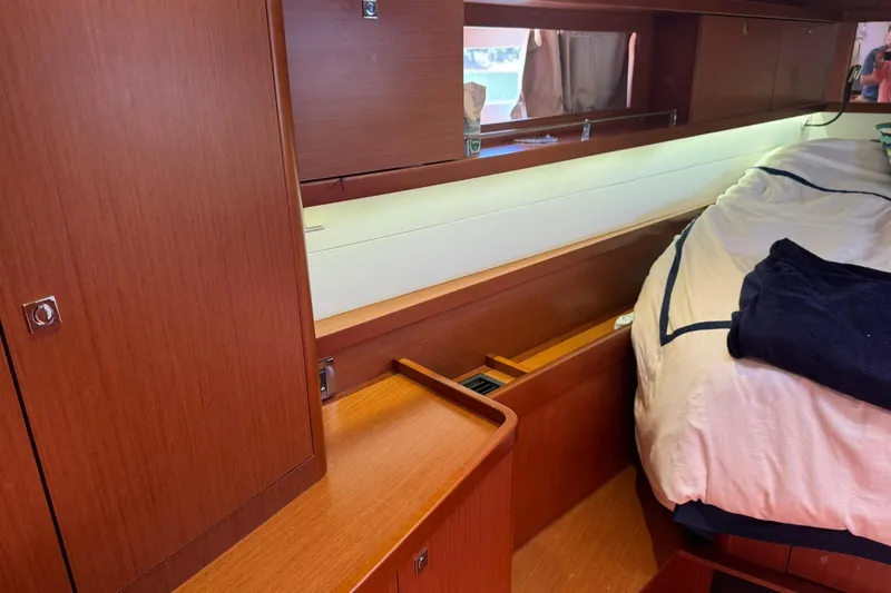 Slide: The Image of Interior of 2014 Beneteau Oceanis 45 yacht with wooden cabinetry and cozy seating area. - 20