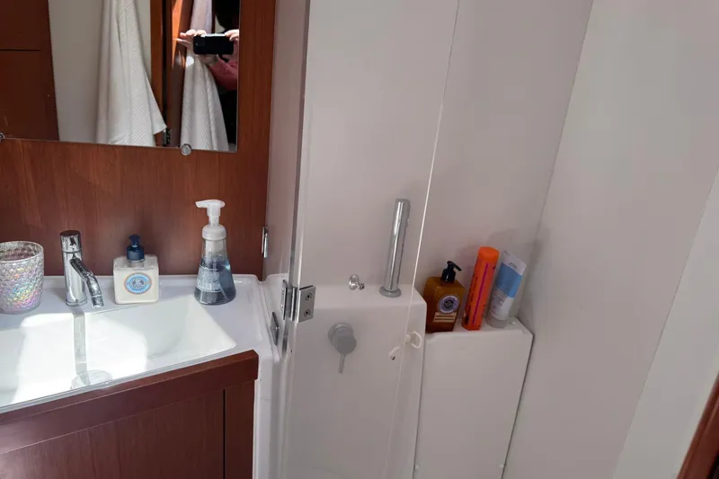 Slide: The Image of Bathroom interior of 2014 Beneteau Oceanis 45 yacht with wooden cabinetry and modern fixtures. - 32