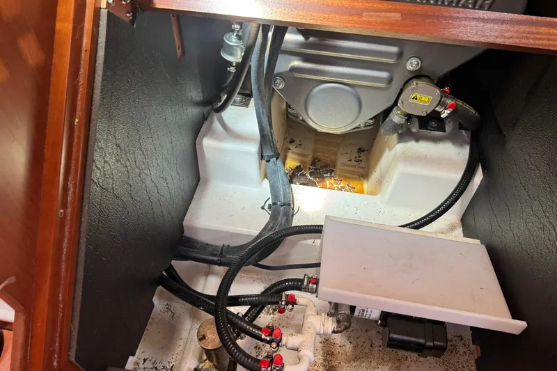 Slide: The Image of Engine compartment of a 2014 Beneteau Oceanis 45 sailboat, showing mechanical components and wiring. - 41