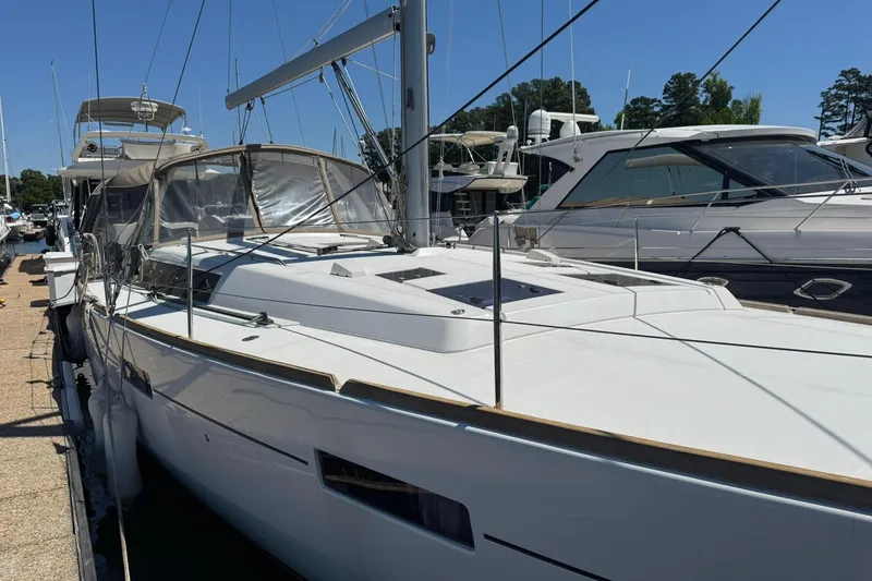 Slide: The Image of 2014 Beneteau Oceanis 45 sailboat docked at marina, showcasing sleek design and modern features. - 5