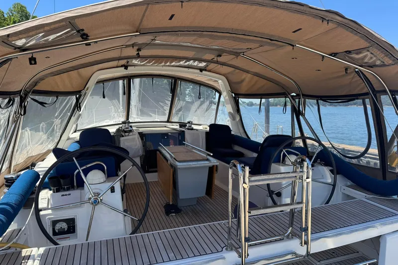 Slide: The Image of 2014 Beneteau Oceanis 45 yacht cockpit with dual steering wheels and spacious seating. - 6