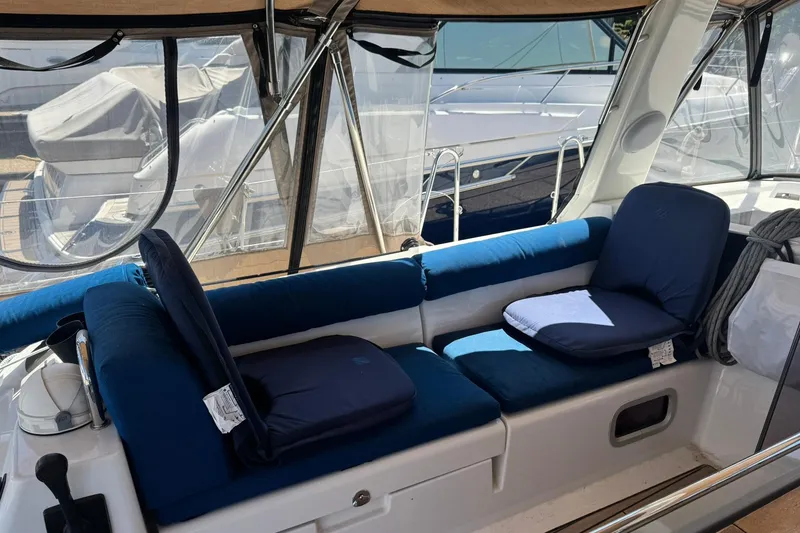Slide: The Image of Interior view of a 2014 Beneteau Oceanis 45 yacht with blue cushioned seating. - 7