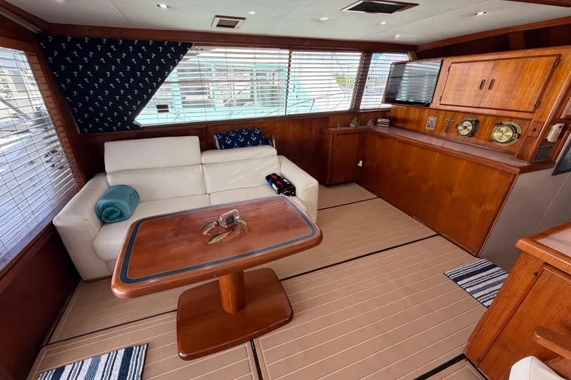 Slide: The Image of Interior of 1986 Bertram 46 Convertible yacht with wooden furnishings and white sofa. - 10
