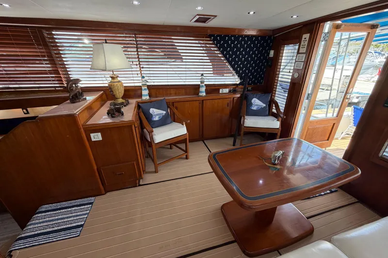 Slide: The Image of Interior of a 1986 Bertram 46 Convertible yacht with wooden furnishings and nautical decor. - 11