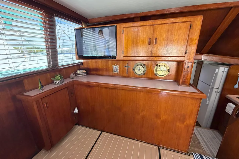 Slide: The Image of Interior of 1986 Bertram 46 Convertible yacht with wooden cabinetry and nautical decor. - 13