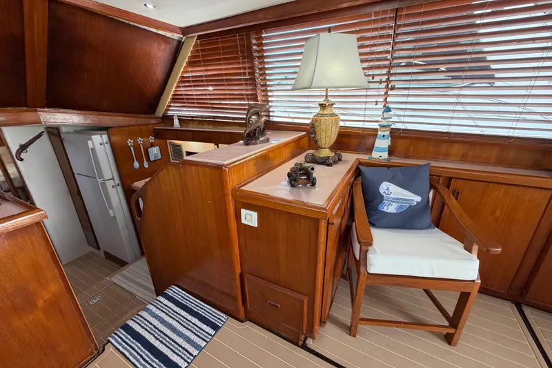 Slide: The Image of Interior of 1986 Bertram 46 Convertible yacht with wooden decor and nautical-themed accents. - 14