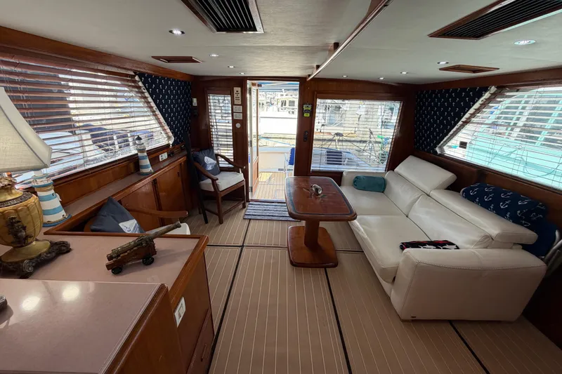 Slide: The Image of Interior of 1986 Bertram 46 Convertible yacht with elegant wood and white leather furnishings. - 15