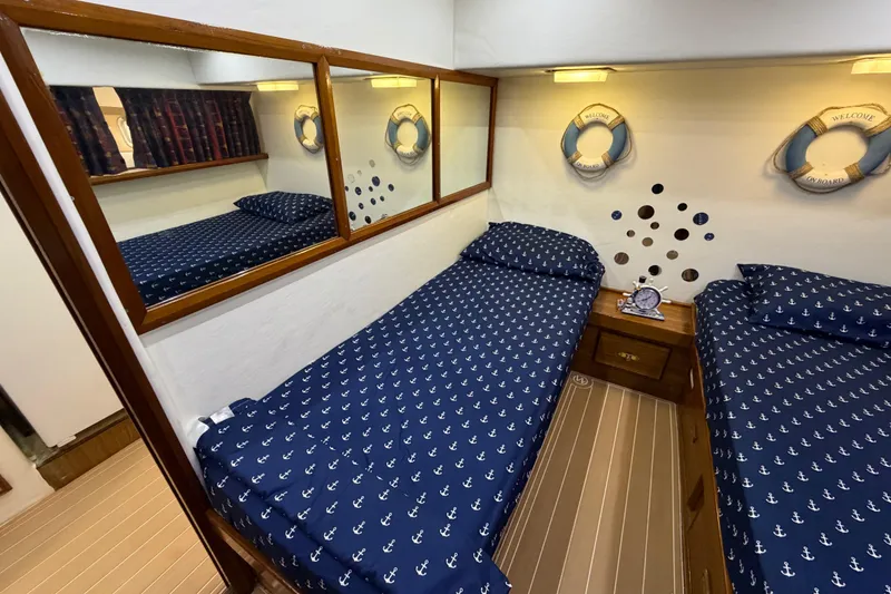 Slide: The Image of Nautical-themed cabin interior of 1986 Bertram 46 Convertible yacht with twin beds. - 26