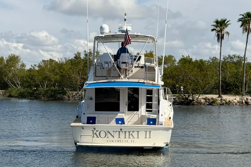 Slide: The Image of 1986 Bertram 46 Convertible yacht "Kontiki II" cruising on a calm waterway. - 3
