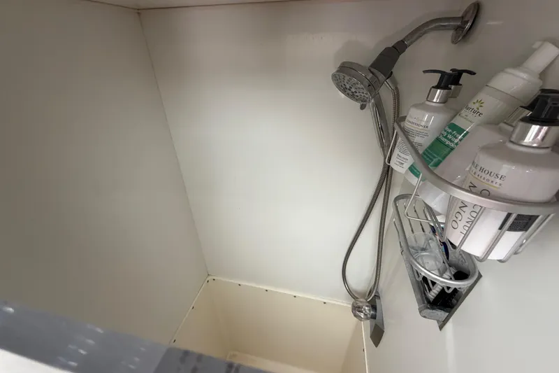 Slide: The Image of Shower area in a 1986 Bertram 46 Convertible yacht with toiletries and showerhead. - 32
