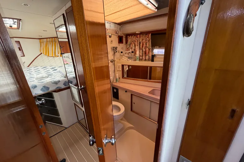 Slide: The Image of Interior of 1986 Bertram 46 Convertible yacht showing bathroom and bedroom. - 35