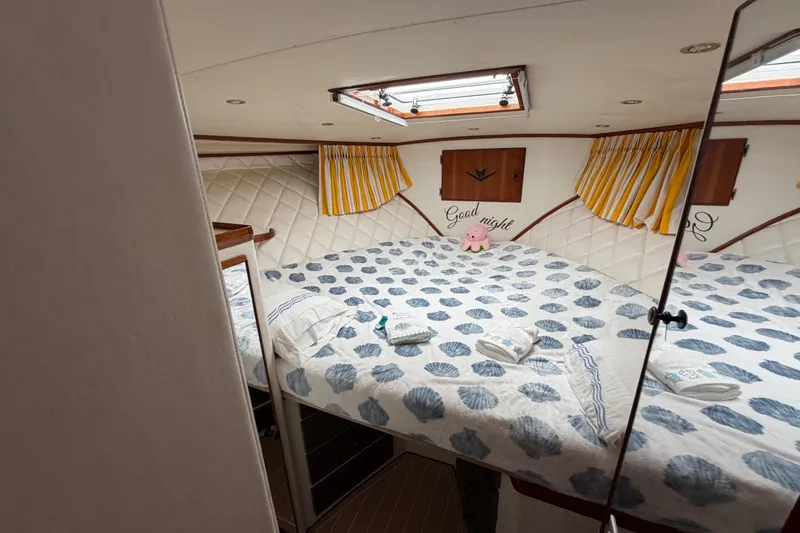 Slide: The Image of Cozy cabin interior of 1986 Bertram 46 Convertible with nautical decor and skylight. - 38