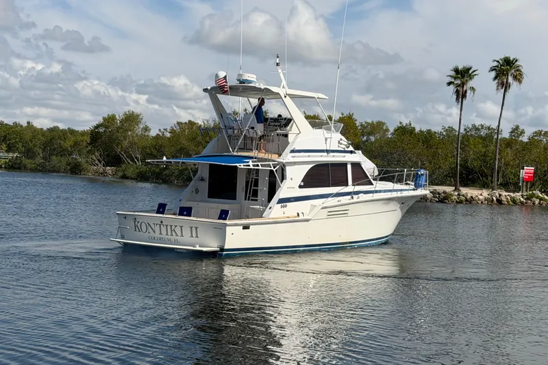 Slide: The Image of 1986 Bertram 46 Convertible yacht "Kontiki II" cruising on a scenic waterway. - 4