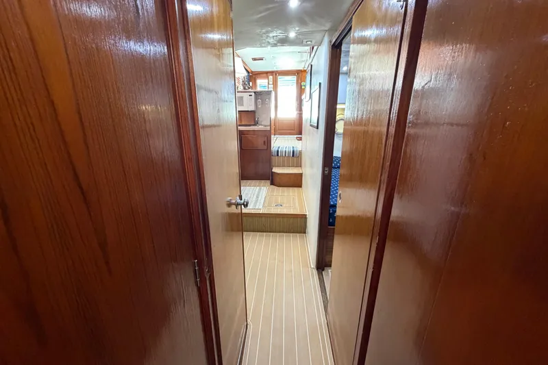 Slide: The Image of Interior hallway of a 1986 Bertram 46 Convertible yacht with wooden finishes. - 43
