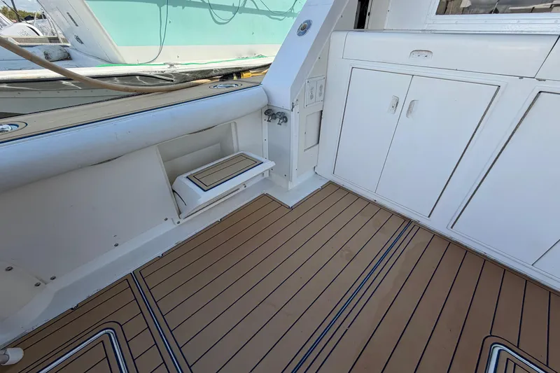 Slide: The Image of Interior view of 1986 Bertram 46 Convertible yacht with teak flooring and white cabinetry. - 49