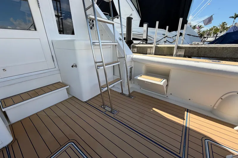 Slide: The Image of 1986 Bertram 46 Convertible yacht deck with ladder and teak flooring. - 51