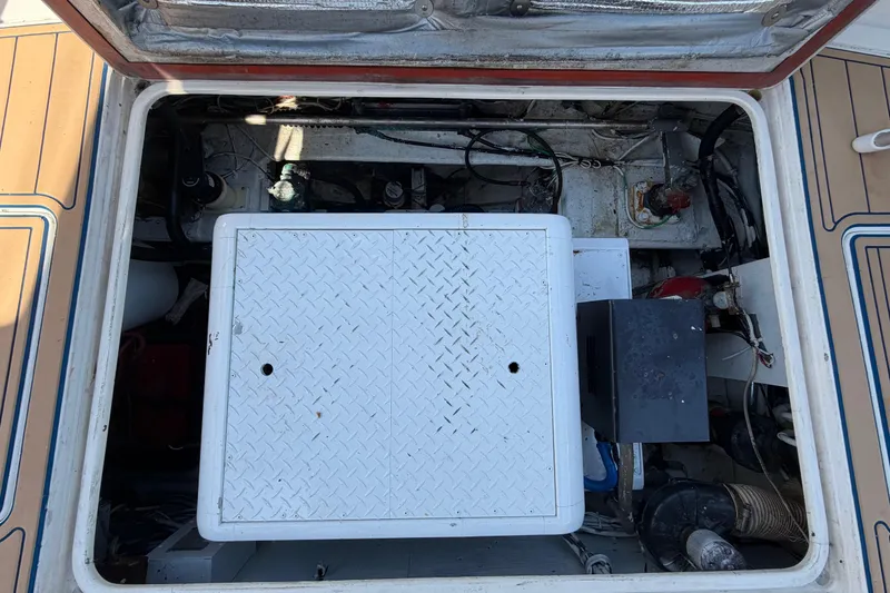 Slide: The Image of Engine compartment of a 1986 Bertram 46 Convertible boat, showing mechanical components. - 55