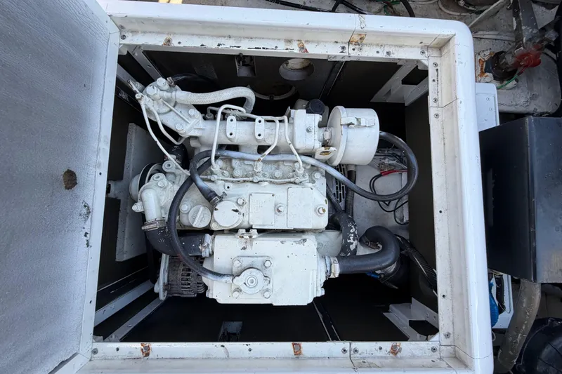 Slide: The Image of Engine compartment of a 1986 Bertram 46 Convertible boat, showcasing mechanical components. - 56