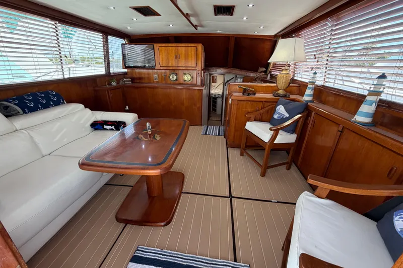 Slide: The Image of Luxurious interior of a 1986 Bertram 46 Convertible yacht with elegant wood finishes. - 6