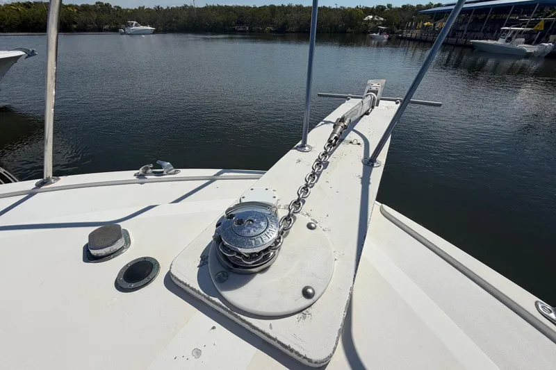 Slide: The Image of Bow of 1986 Bertram 46 Convertible yacht with anchor chain and calm water view. - 62