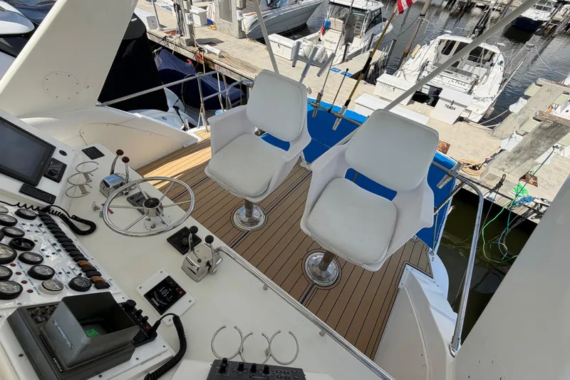 Slide: The Image of Cockpit view of a 1986 Bertram 46 Convertible yacht with dual helm chairs. - 68