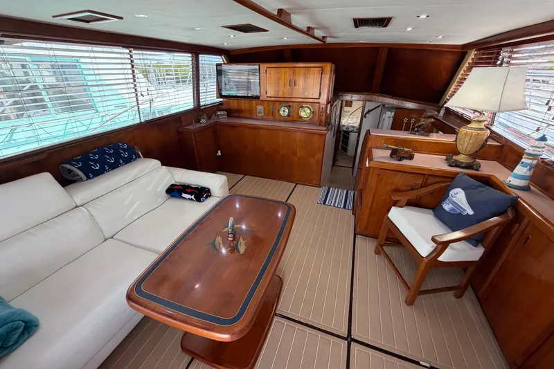 Slide: The Image of Luxurious interior of a 1986 Bertram 46 Convertible yacht with elegant wood finishes. - 7