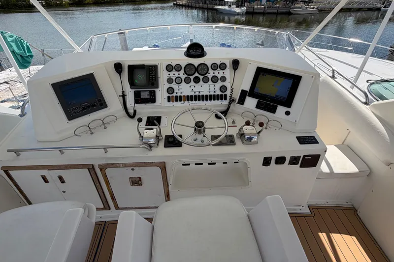 Slide: The Image of 1986 Bertram 46 Convertible yacht helm with navigation instruments and steering wheel. - 72