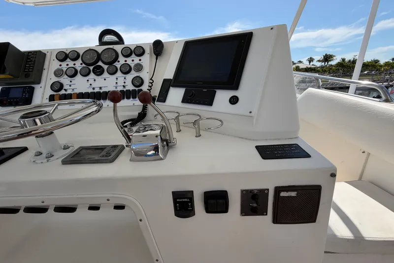 Slide: The Image of Control panel of a 1986 Bertram 46 Convertible yacht with gauges and navigation equipment. - 74