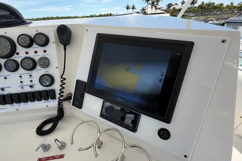 Slide: The Image of Control panel of a 1986 Bertram 46 Convertible yacht with navigation display and gauges. - 75