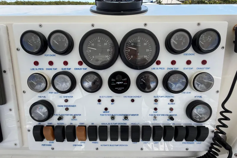 Slide: The Image of Control panel of a 1986 Bertram 46 Convertible boat with gauges and switches. - 76